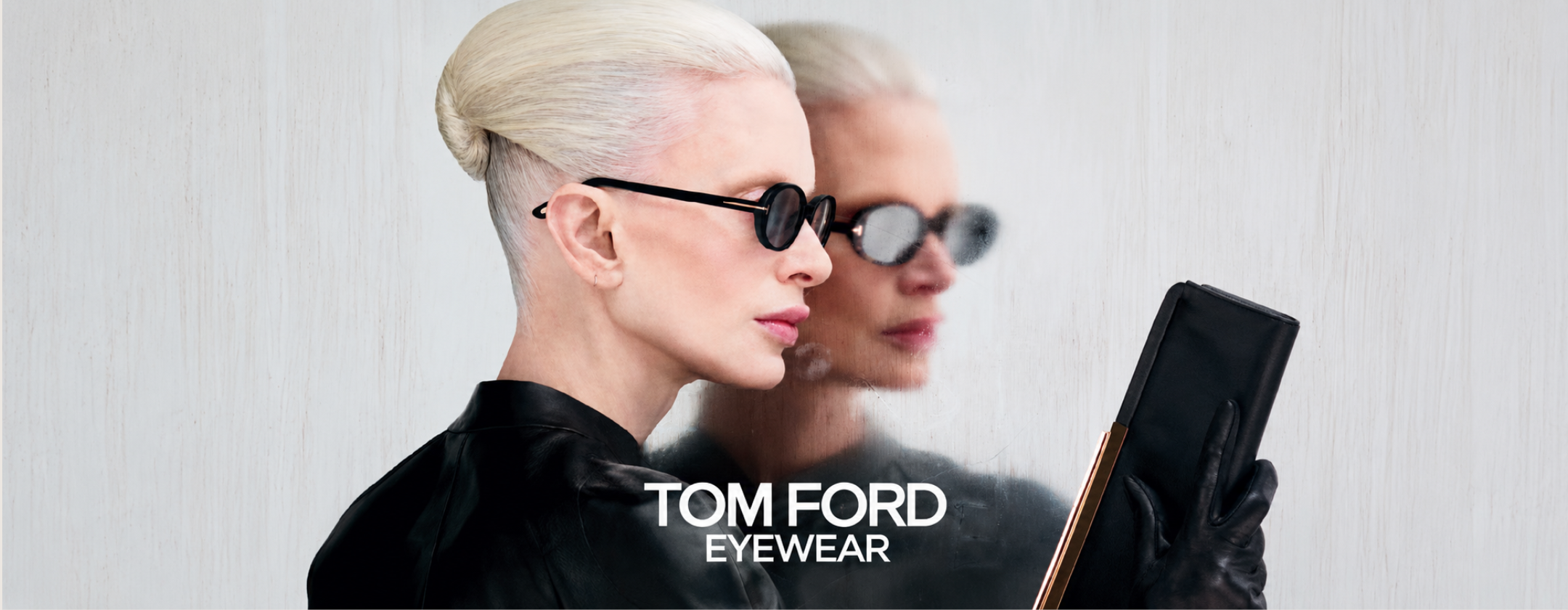 Tom Ford Eyewear campaign featuring a model wearing black round sunglasses with a minimalist luxury fashion aesthetic.